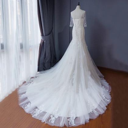 Long Sleeve Mermaid Wedding Dress Featuring Lace..